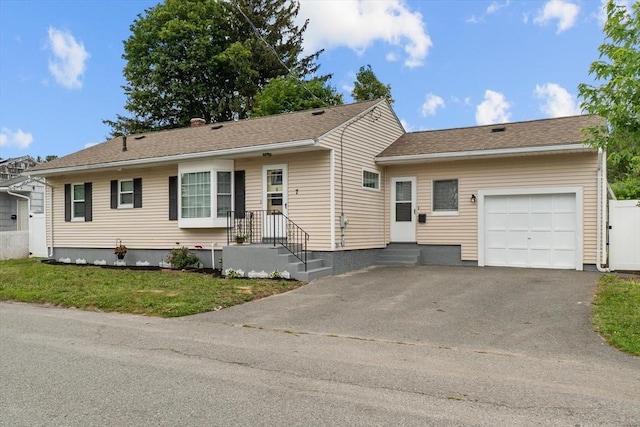 7 Burgess St, Methuen, MA 01844 - single story home with a garage, asphalt driveway, and a front lawn