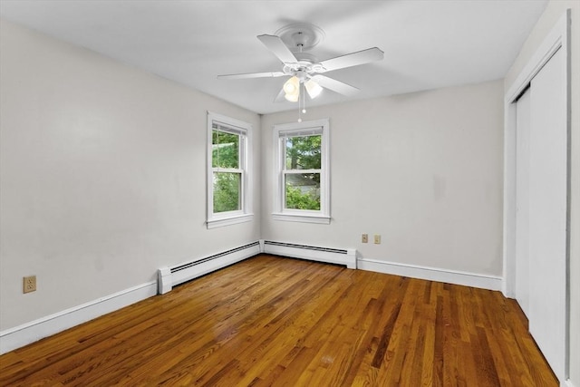 7 Burgess St, Methuen, MA 01844 - unfurnished bedroom featuring baseboard heating, wood finished floors, a closet, and a ceiling fan