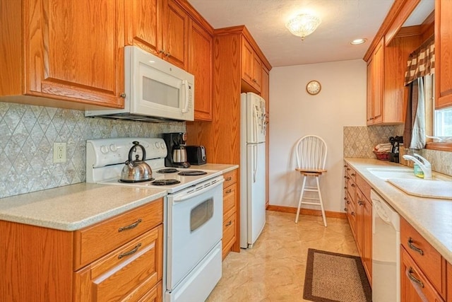 7 Chandler Way Unit 7, Northborough, MA 01532 - kitchen featuring white appliances, light countertops, decorative backsplash, and brown cabinetry
