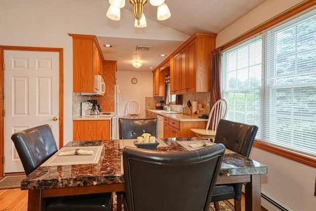 7 Chandler Way Unit 7, Northborough, MA 01532 - dining room with a baseboard heating unit, vaulted ceiling, and light wood-type flooring
