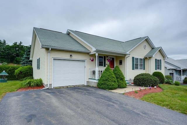 7 Chandler Way Unit 7, Northborough, MA 01532 - view of front of home with a garage, asphalt driveway, covered porch, and a front lawn
