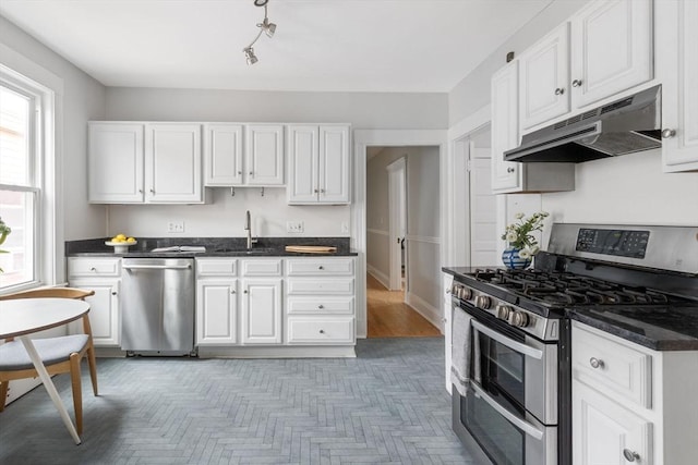 39 Calvin St Unit 3, Somerville, MA 02143 - kitchen with stainless steel appliances, under cabinet range hood, plenty of natural light, and white cabinets