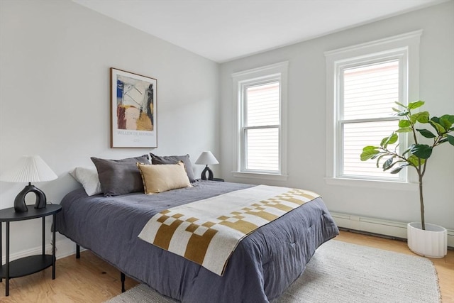 39 Calvin St Unit 3, Somerville, MA 02143 - bedroom featuring wood finished floors and a baseboard radiator