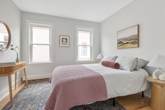 39 Calvin St Unit 3, Somerville, MA 02143 - bedroom featuring a baseboard heating unit and wood finished floors