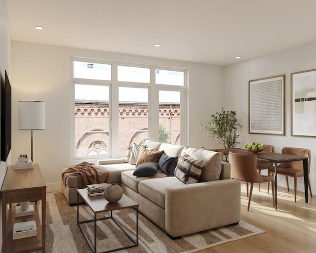 living area with light wood-style floors, baseboards, and recessed lighting