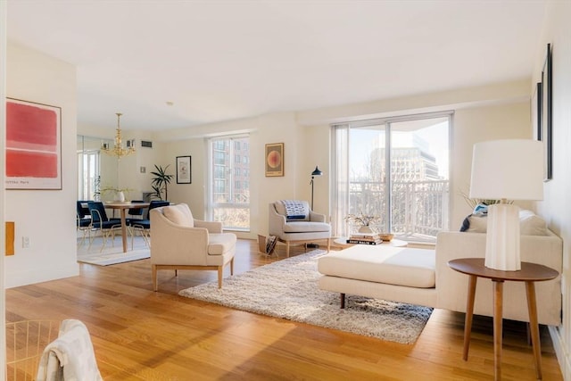 living room with a chandelier and wood-type flooring