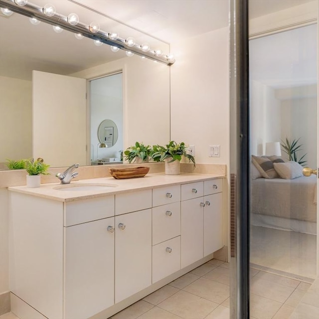 bathroom featuring tile patterned flooring and vanity