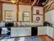 kitchen featuring white cabinets and beam ceiling