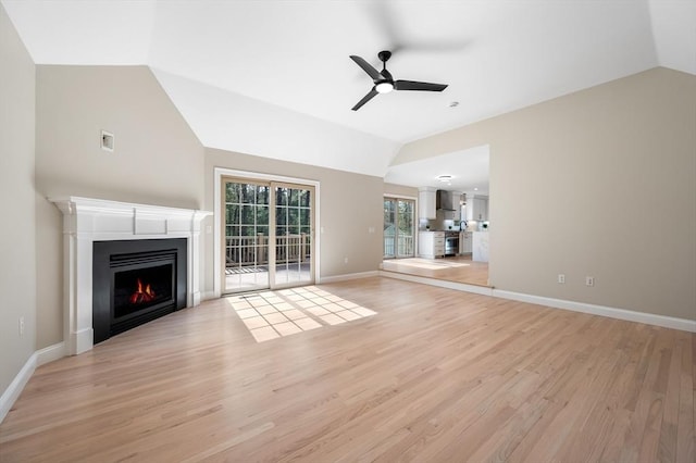 46 Mansfield Ave, Norton, MA 02766 - unfurnished living room with lofted ceiling, light wood-type flooring, a ceiling fan, and a lit fireplace
