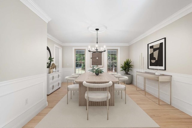 46 Mansfield Ave, Norton, MA 02766 - dining area featuring crown molding, light wood-style floors, a wainscoted wall, an inviting chandelier, and a decorative wall