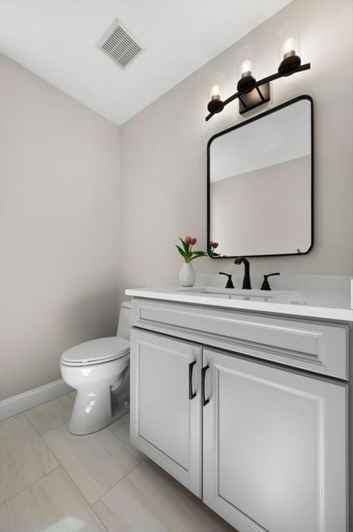 46 Mansfield Ave, Norton, MA 02766 - half bath with toilet, visible vents, and vanity