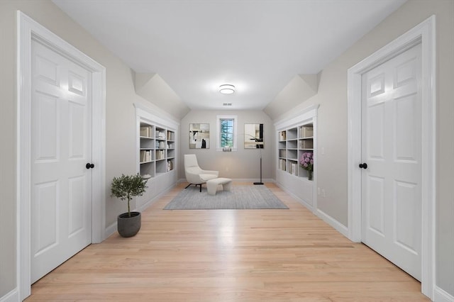 46 Mansfield Ave, Norton, MA 02766 - living area featuring built in shelves, light wood-type flooring, and baseboards