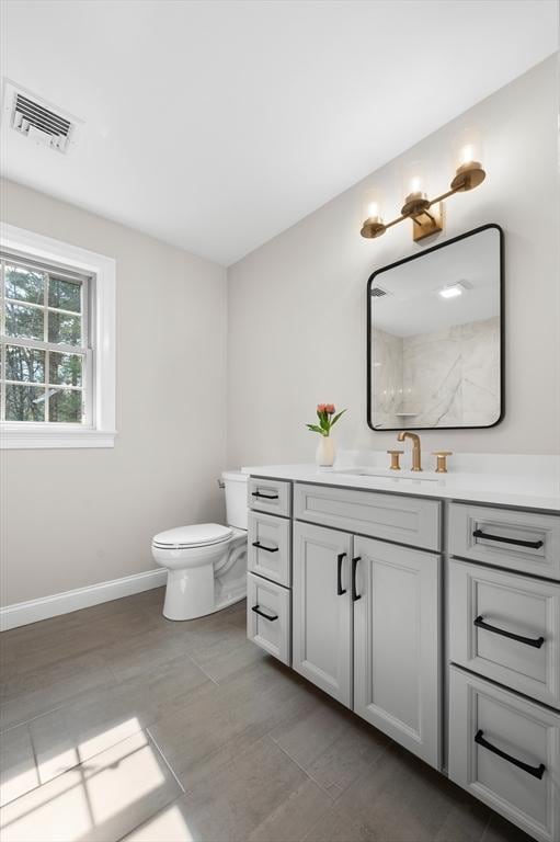 46 Mansfield Ave, Norton, MA 02766 - full bathroom with baseboards, visible vents, toilet, and vanity
