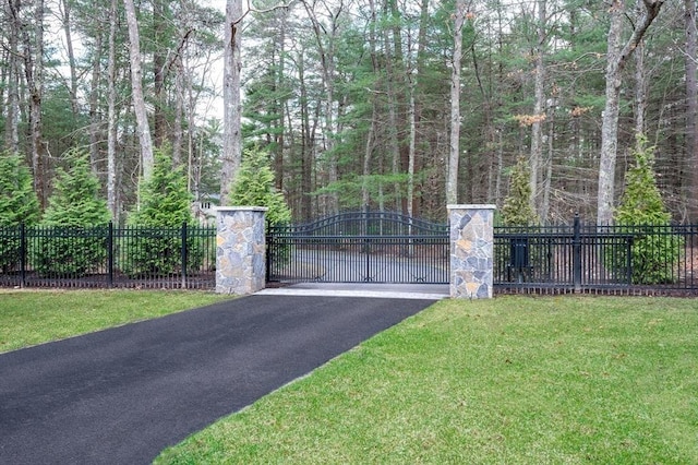 46 Mansfield Ave, Norton, MA 02766 - view of gate featuring a wooded view, fence, and a lawn