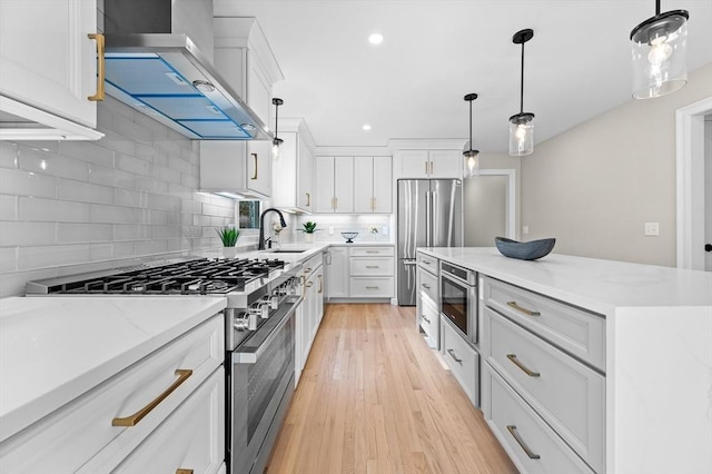 46 Mansfield Ave, Norton, MA 02766 - kitchen featuring wall chimney exhaust hood, a sink, backsplash, and appliances with stainless steel finishes