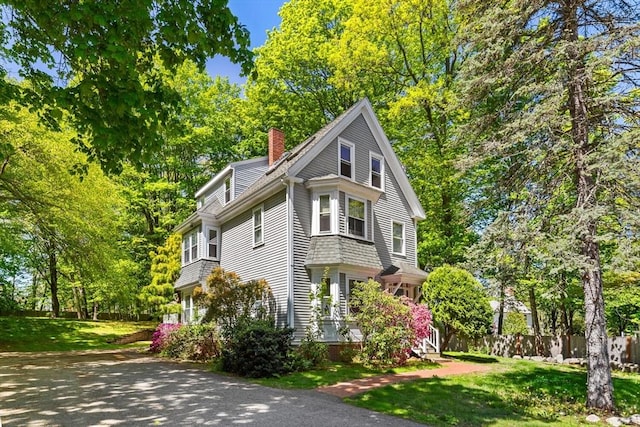 956 Bay Rd Unit 1, Hamilton, MA 01982 - view of home's exterior with a chimney and view of wooded area