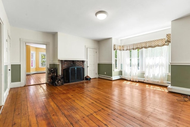 956 Bay Rd Unit 1, Hamilton, MA 01982 - unfurnished living room with wood-type flooring, baseboards, a brick fireplace, and a baseboard radiator
