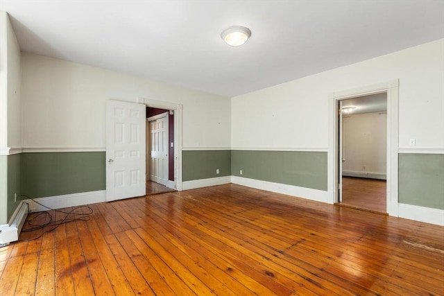 956 Bay Rd Unit 1, Hamilton, MA 01982 - spare room with a baseboard heating unit, hardwood / wood-style flooring, and baseboards