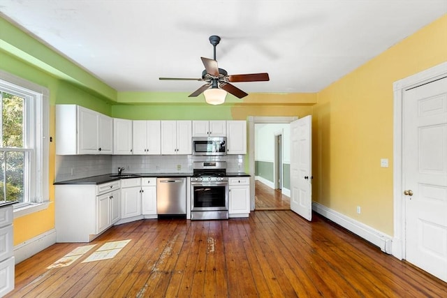 956 Bay Rd Unit 1, Hamilton, MA 01982 - kitchen featuring stainless steel appliances, a sink, tasteful backsplash, and dark countertops