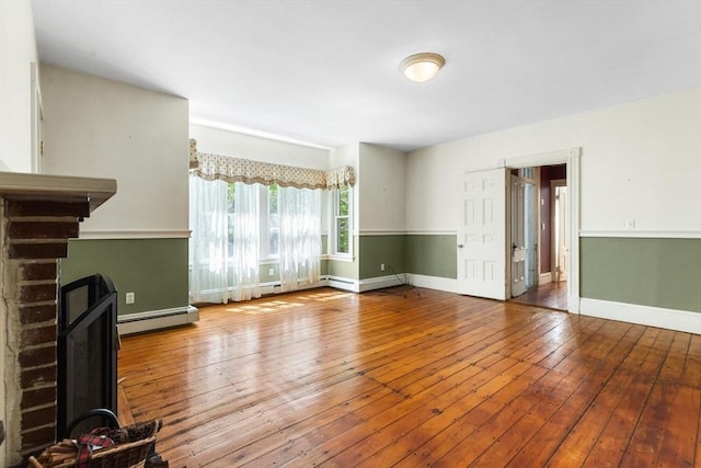 956 Bay Rd Unit 1, Hamilton, MA 01982 - unfurnished living room with a baseboard heating unit, hardwood / wood-style floors, and baseboards