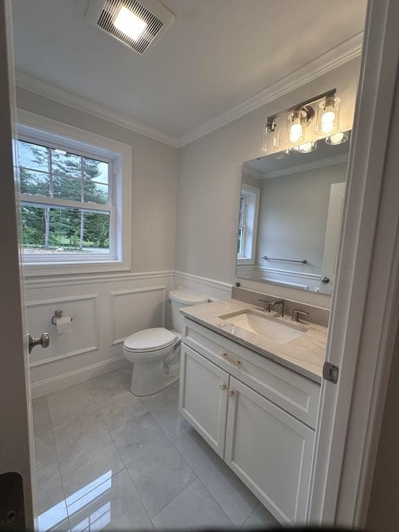 58 Dudley Rd, Billerica, MA 01821 - bathroom featuring toilet, vanity, ornamental molding, and wainscoting