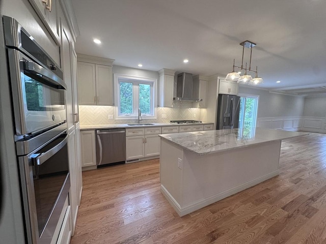 58 Dudley Rd, Billerica, MA 01821 - kitchen with appliances with stainless steel finishes, wall chimney exhaust hood, a sink, a center island, and light wood finished floors