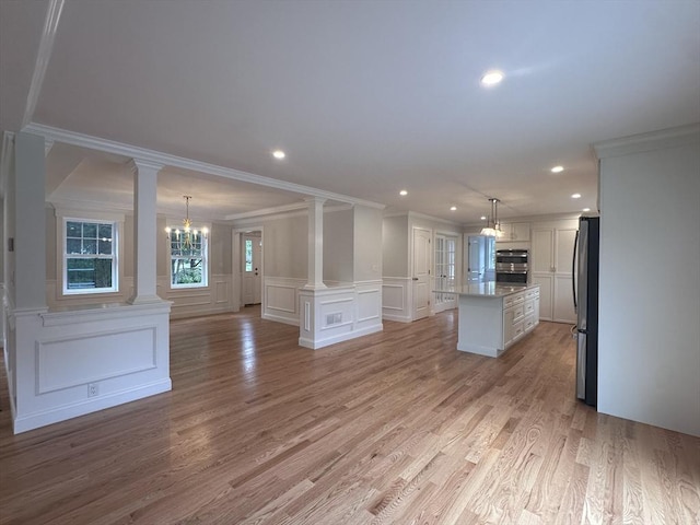 58 Dudley Rd, Billerica, MA 01821 - kitchen with appliances with stainless steel finishes, a decorative wall, crown molding, ornate columns, and a kitchen island