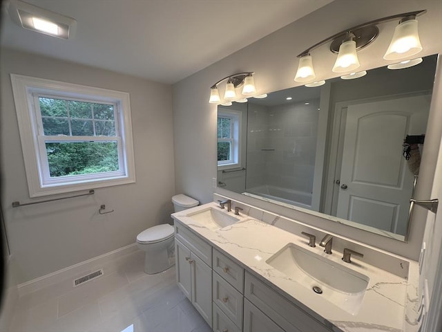 58 Dudley Rd, Billerica, MA 01821 - bathroom with double vanity, toilet, baseboards, shower / tub combination, and tile patterned floors