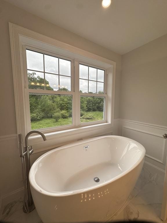 58 Dudley Rd, Billerica, MA 01821 - full bathroom with marble look tile flooring, a soaking tub, wainscoting, and recessed lighting