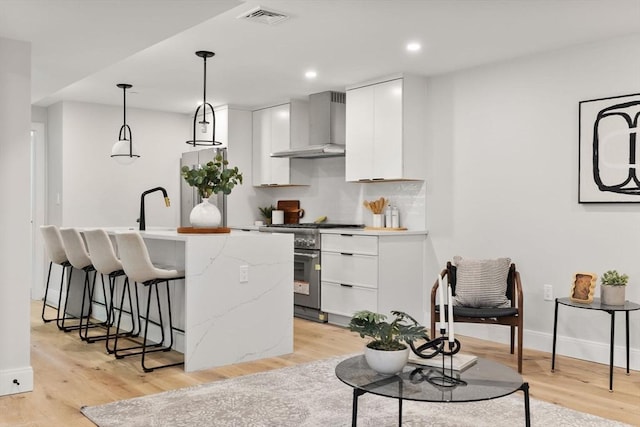 190 Salem St Unit 2, Boston, MA 02113 - kitchen featuring wall chimney range hood, high end stove, light wood finished floors, and recessed lighting