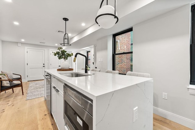 190 Salem St Unit 2, Boston, MA 02113 - kitchen featuring a sink, stainless steel microwave, a center island with sink, light wood-type flooring, and recessed lighting