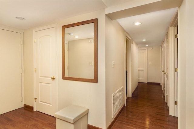 hallway with recessed lighting, visible vents, baseboards, and wood finished floors