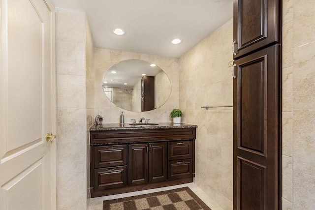 bathroom featuring vanity, tile walls, and recessed lighting