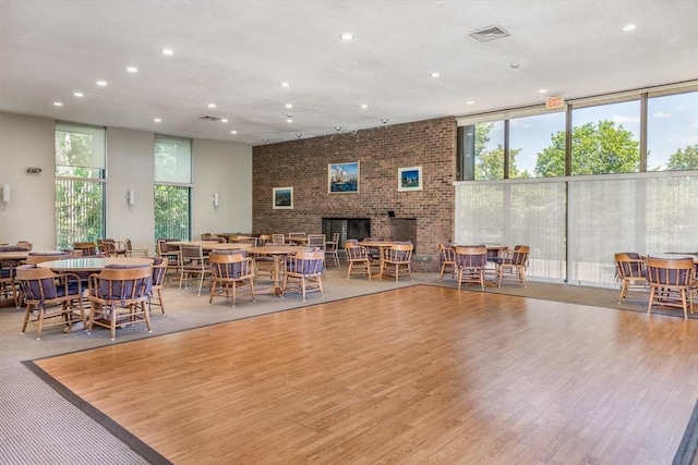 dining space featuring expansive windows, a healthy amount of sunlight, and visible vents