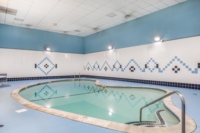 view of pool with a hot tub