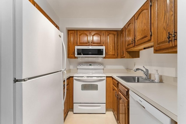 357 Commercial St Unit 219, Boston, MA 02109 - kitchen featuring white appliances, a sink, brown cabinets, and light countertops