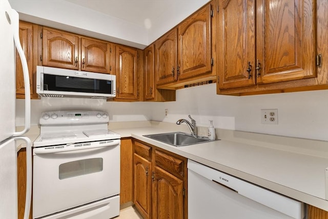 357 Commercial St Unit 219, Boston, MA 02109 - kitchen with white appliances, a sink, brown cabinets, and light countertops