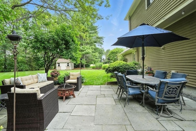 56 R F Higgins Dr, Norwell, MA 02061 - view of patio featuring outdoor dining space, an outdoor living space with a fire pit, and a storage shed