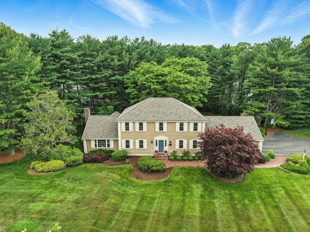 56 R F Higgins Dr, Norwell, MA 02061 - colonial house with a chimney, a front lawn, and a shingled roof