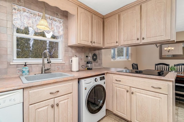 laundry area featuring laundry area, light tile patterned floors, washer / clothes dryer, and a sink