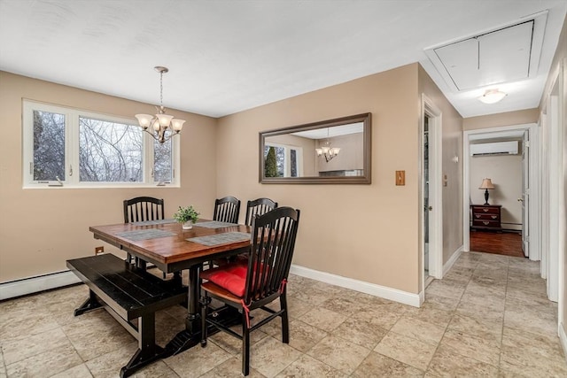 dining space with attic access, baseboards, an inviting chandelier, an AC wall unit, and a baseboard heating unit