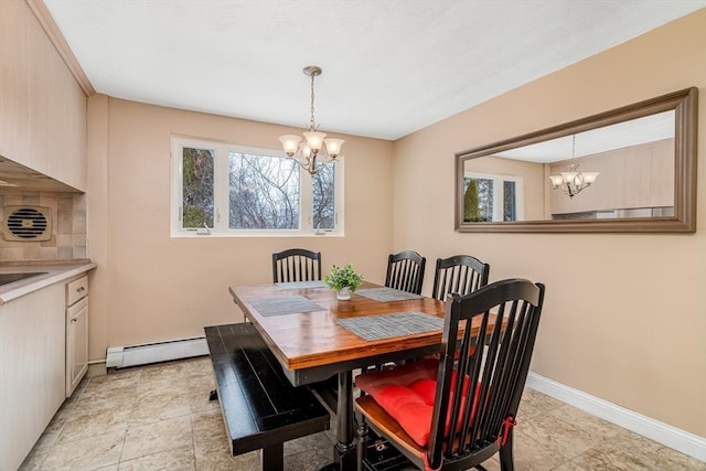 dining area with a baseboard heating unit, baseboards, and a notable chandelier