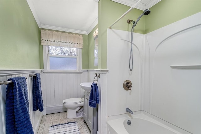 full bath with ornamental molding, shower / bath combination, wainscoting, and toilet