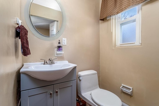 half bathroom with toilet and vanity