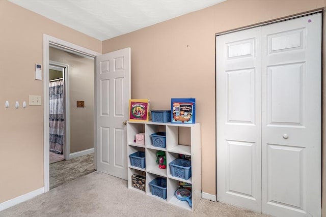 game room with light carpet and baseboards