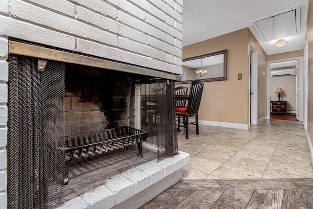 room details with a baseboard radiator, a wall mounted air conditioner, and baseboards