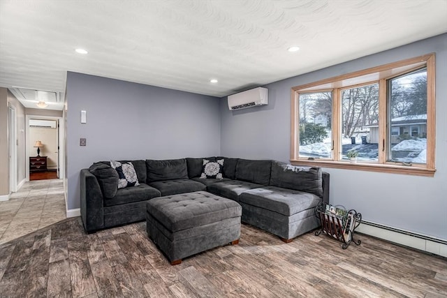 living area with attic access, a wall unit AC, a baseboard radiator, wood finished floors, and recessed lighting