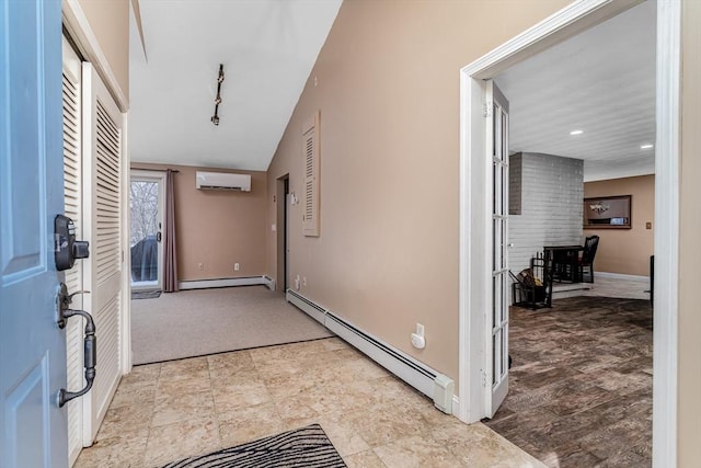 entryway featuring baseboard heating, a wall mounted air conditioner, rail lighting, and baseboards