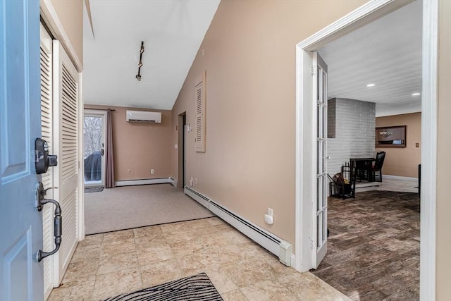 foyer entrance featuring a baseboard heating unit, baseboards, track lighting, and a wall mounted AC