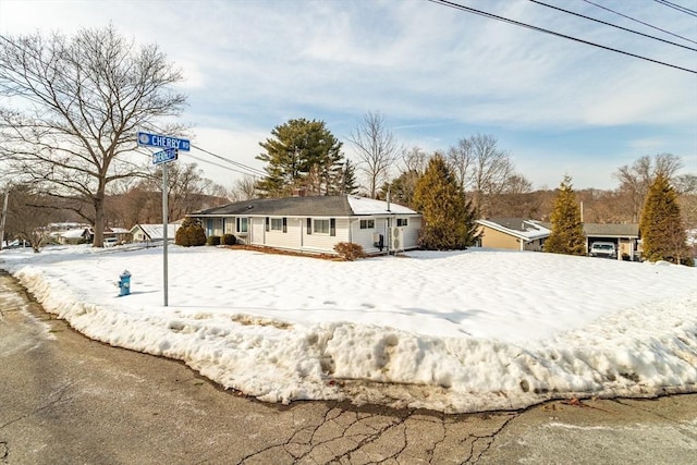 view of snow covered rear of property